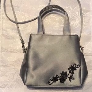 Silver satin evening bag with black beading detail in corner, handle & Strap